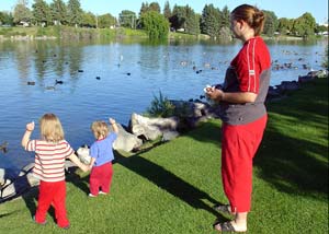 Mom & children feeding ducks